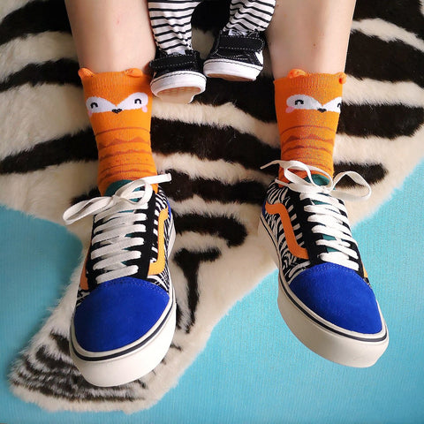 A Girl Wearing Fox Socks and Vans Trainers