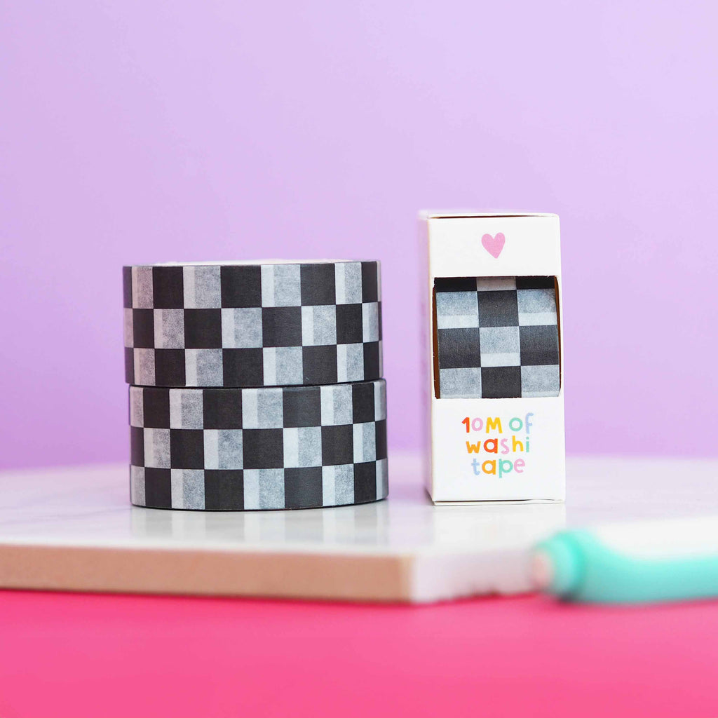 Black and white checkerboard washi tape stacked. Image shows the washi tape in a box.