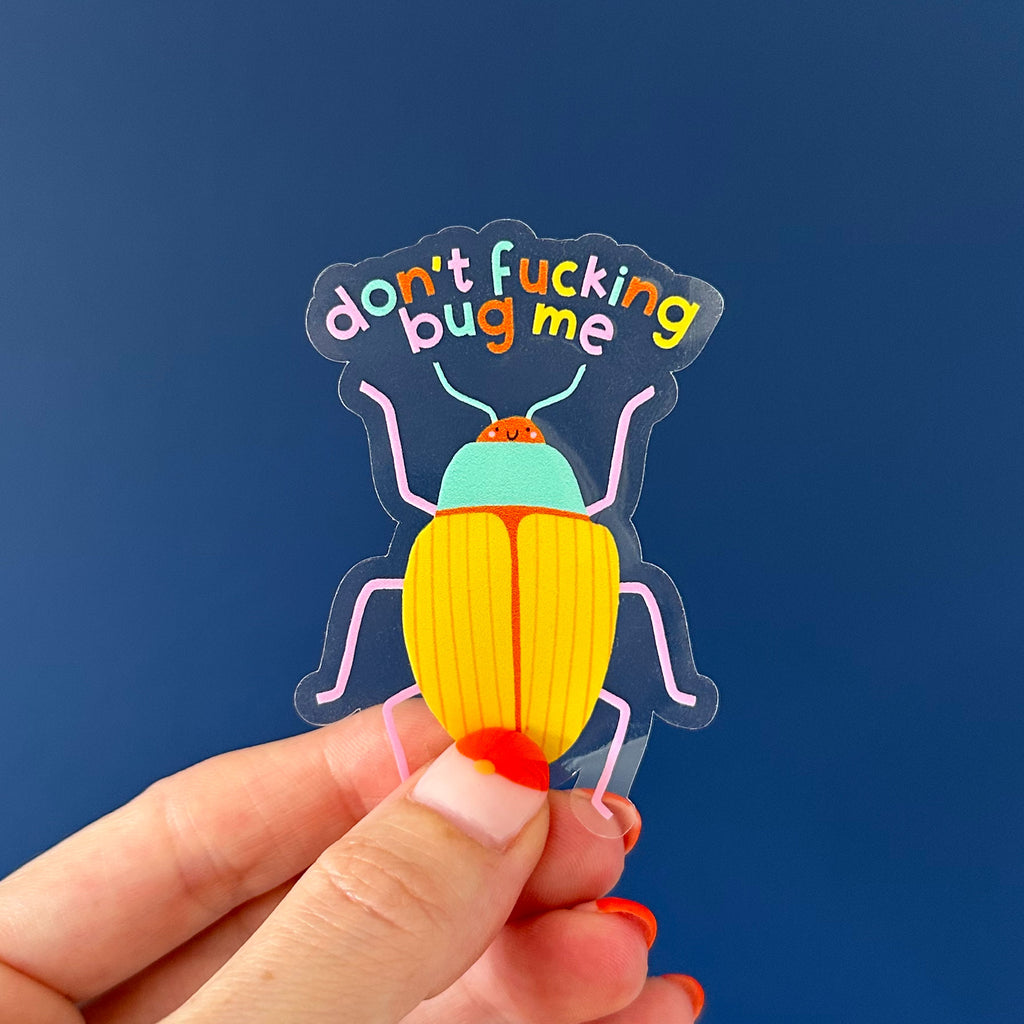 Clear Vinyl Don't Fucking Bug Me Sticker. On a blue background. Perfect for journals and water bottles. Nutmeg and Arlo 