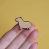A hand holding a capybara pin. - Nutmeg and Arlo