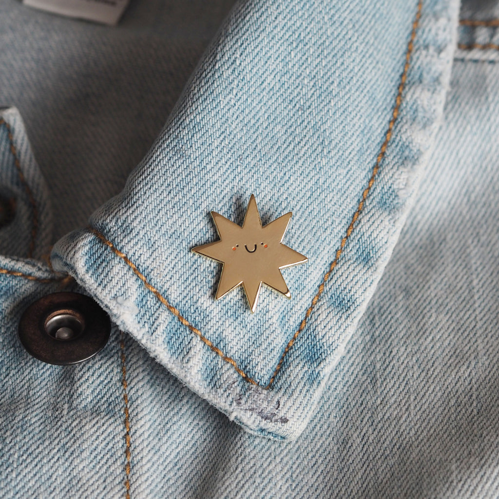 Gold star enamel pin on a denim jacket - Nutmeg and arlo